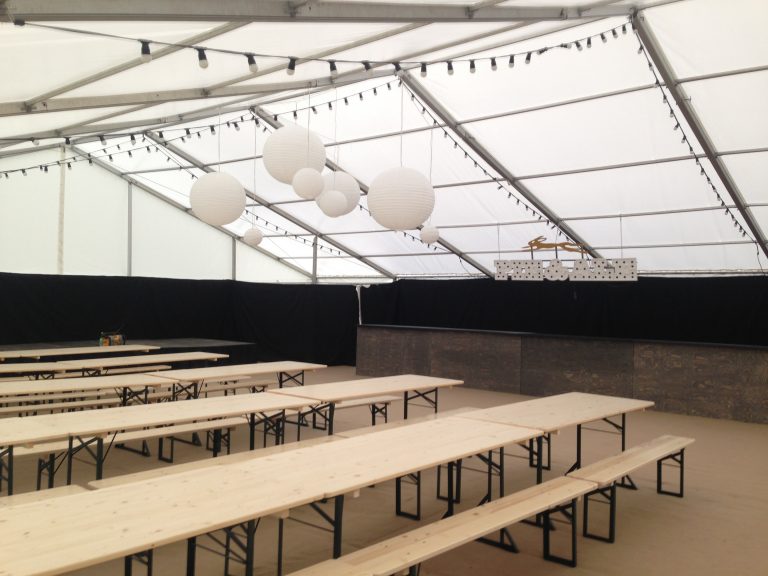 Beer festival tables and benches in a clearspan marquee